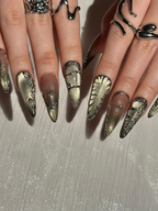 Gothic Celestial Press On Nails. Dark Cat Eye Galaxy Nails with Silver Stars. Edgy Ethereal Stiletto Nails with Metallic Charms. OC1289HC