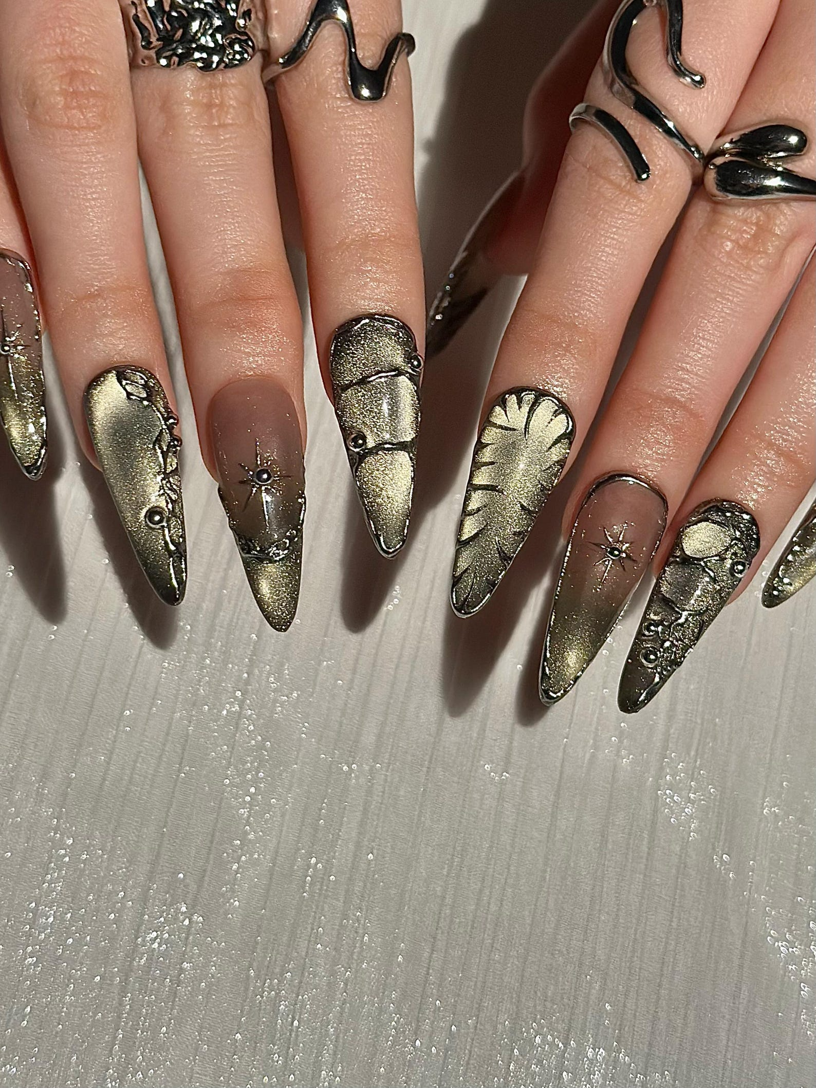 Gothic Celestial Press On Nails. Dark Cat Eye Galaxy Nails with Silver Stars. Edgy Ethereal Stiletto Nails with Metallic Charms. OC1289HC