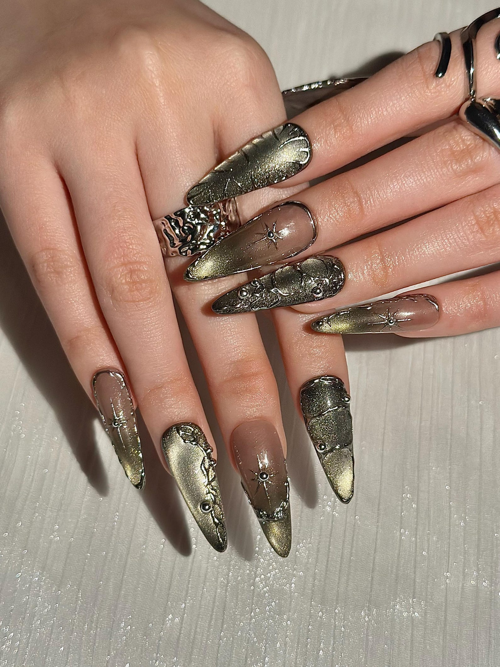 Gothic Celestial Press On Nails. Dark Cat Eye Galaxy Nails with Silver Stars. Edgy Ethereal Stiletto Nails with Metallic Charms. OC1289HC