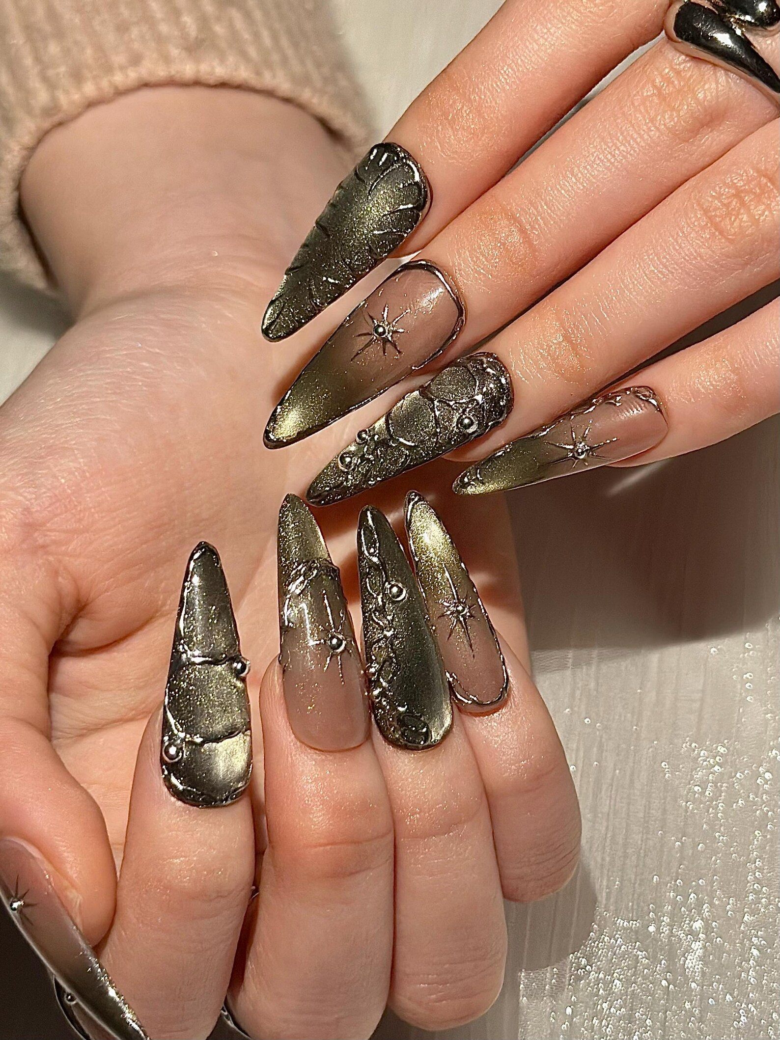 Gothic Celestial Press On Nails. Dark Cat Eye Galaxy Nails with Silver Stars. Edgy Ethereal Stiletto Nails with Metallic Charms. OC1289HC